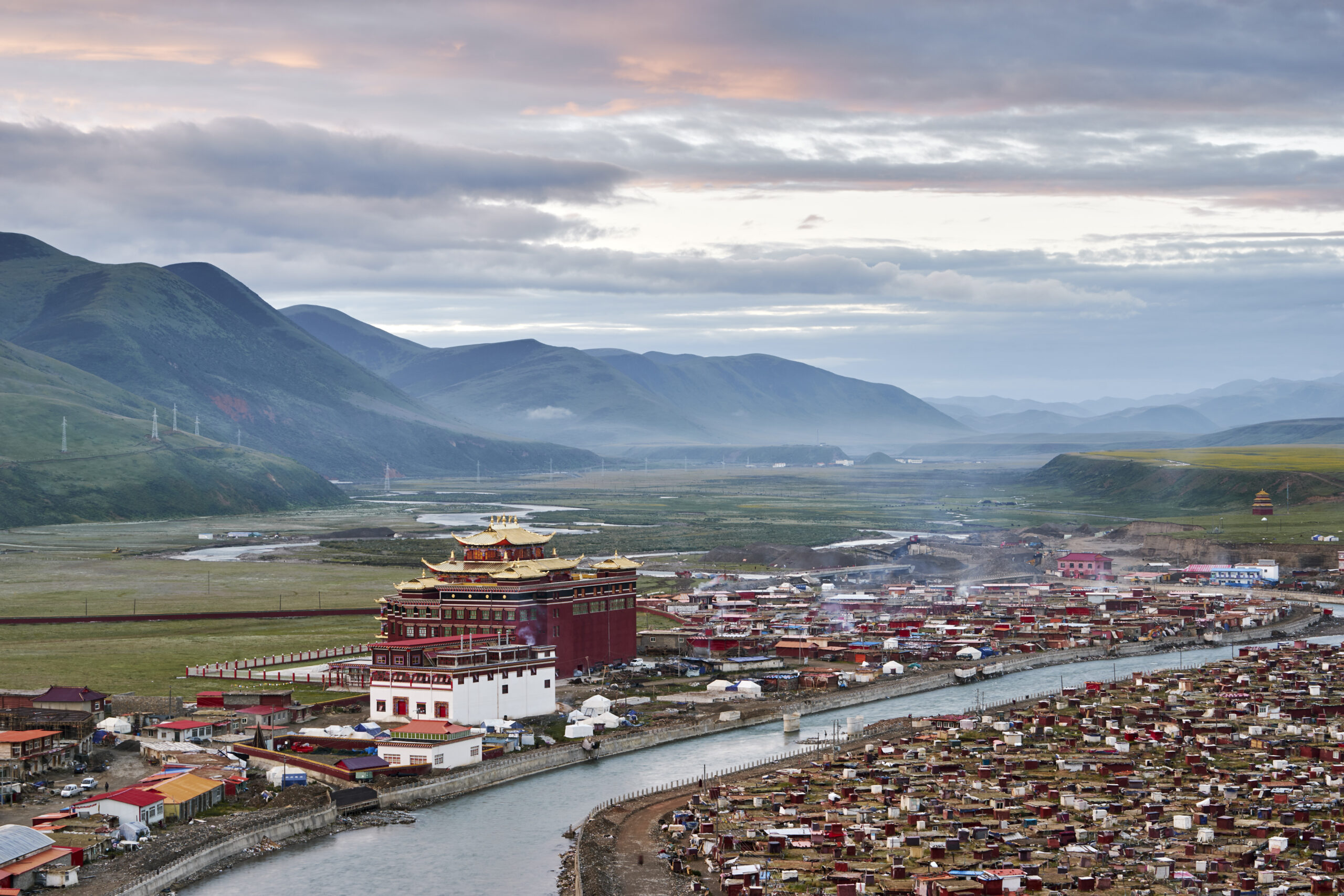 Elevated view of river and valley town, Baiyu, Sichuan, China