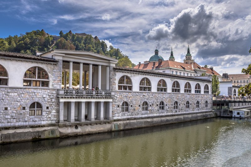 LJUBLJANA, SLOVENIA, AUGUST 11 2017: Cityscape view on Ljubljanica river canal and university in Ljubljana old town
