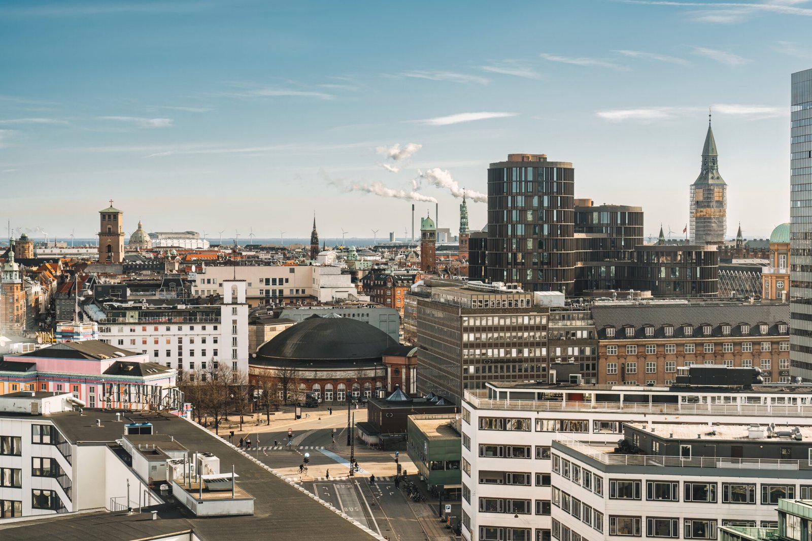 Aerial view of Copenhagen downtown city with business building, clock tower, church, castle on sunny day at Denmark