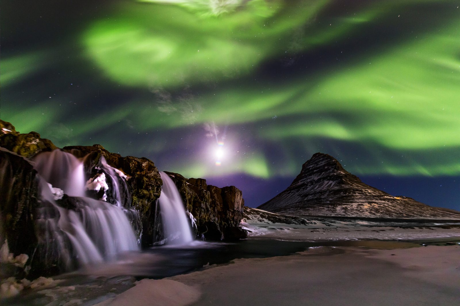 Northern Light, Aurora borealis at Kirkjufell in Iceland. Kirkjufell mountains in winter