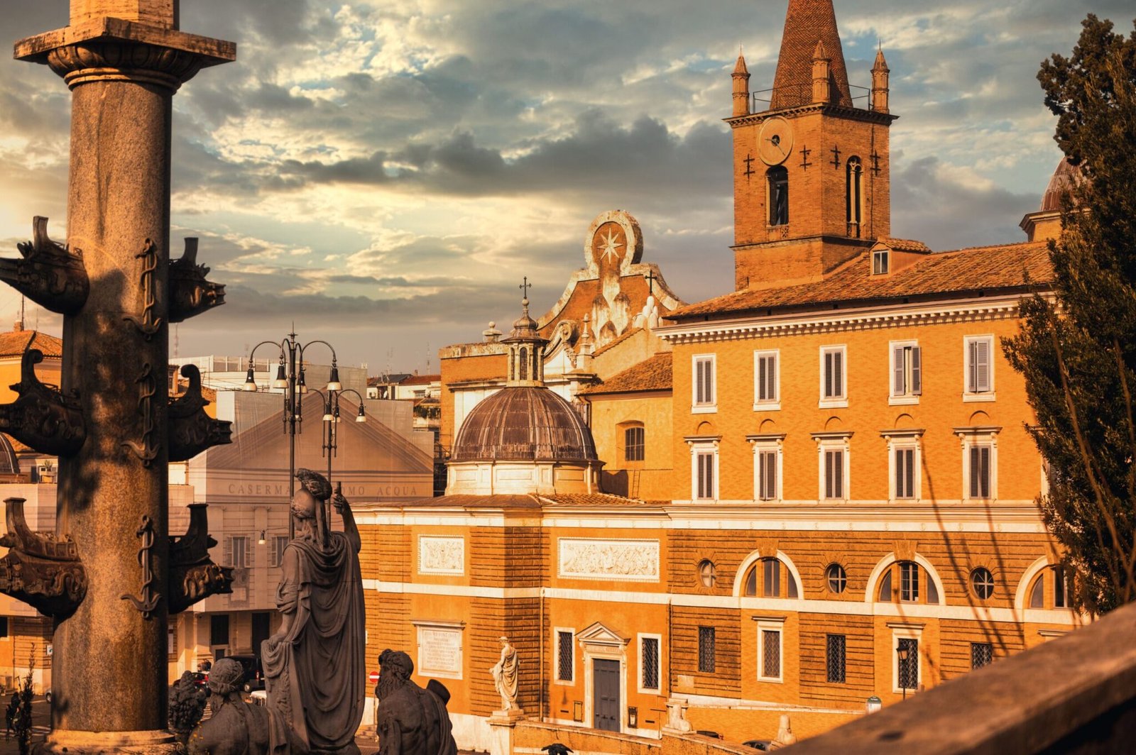 A sceni view of statues in front of a majestic building under a cloudy sky in Rome, Italy